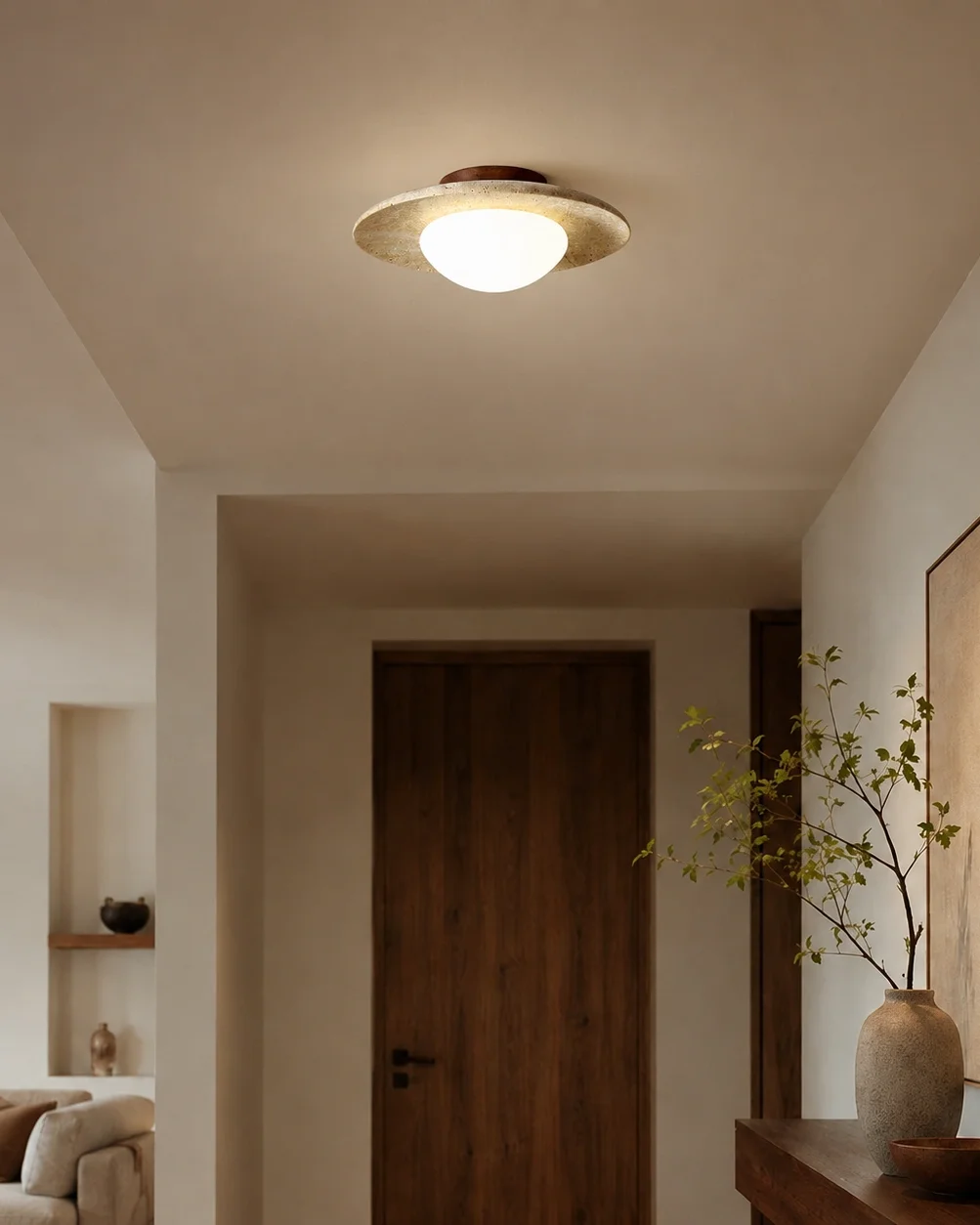 The Eclipse travertine and walnut ceiling light in a calm hallway