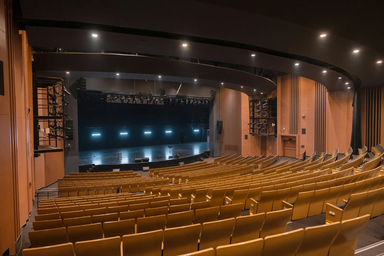Auditorium with recessed ceiling downlights over tiered seating