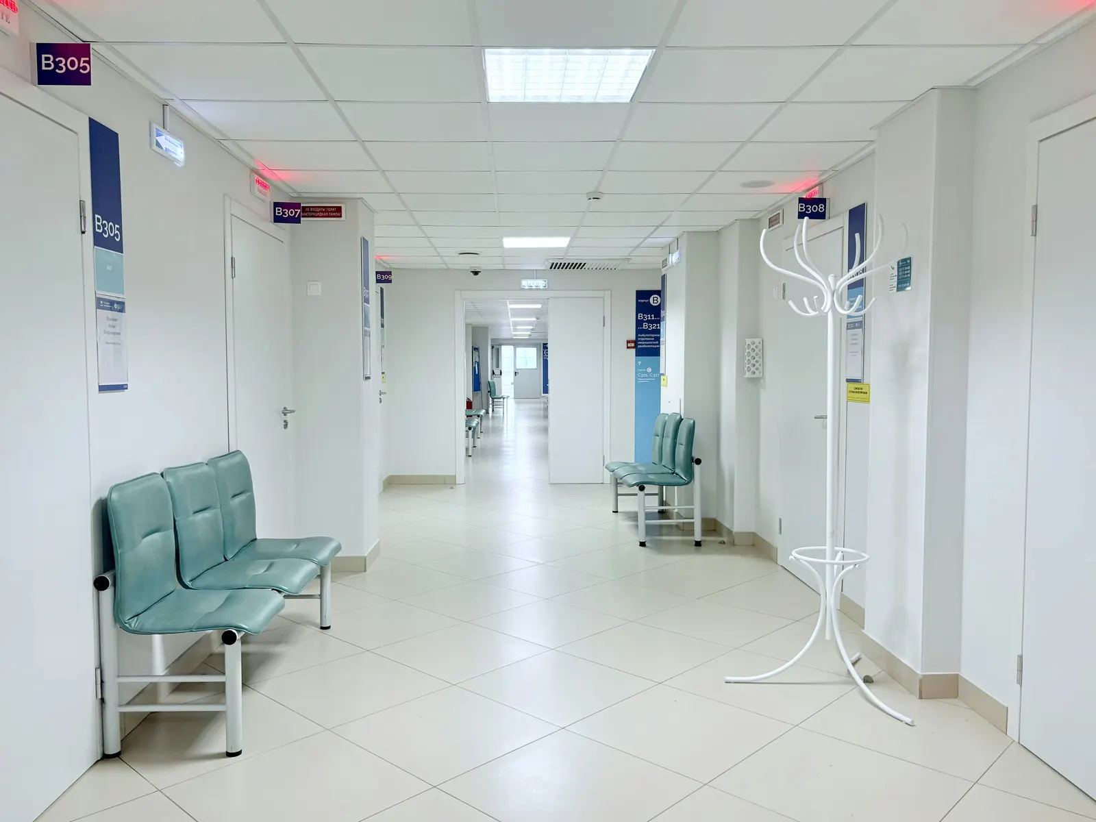 Clean hospital corridor lit by recessed ceiling panels