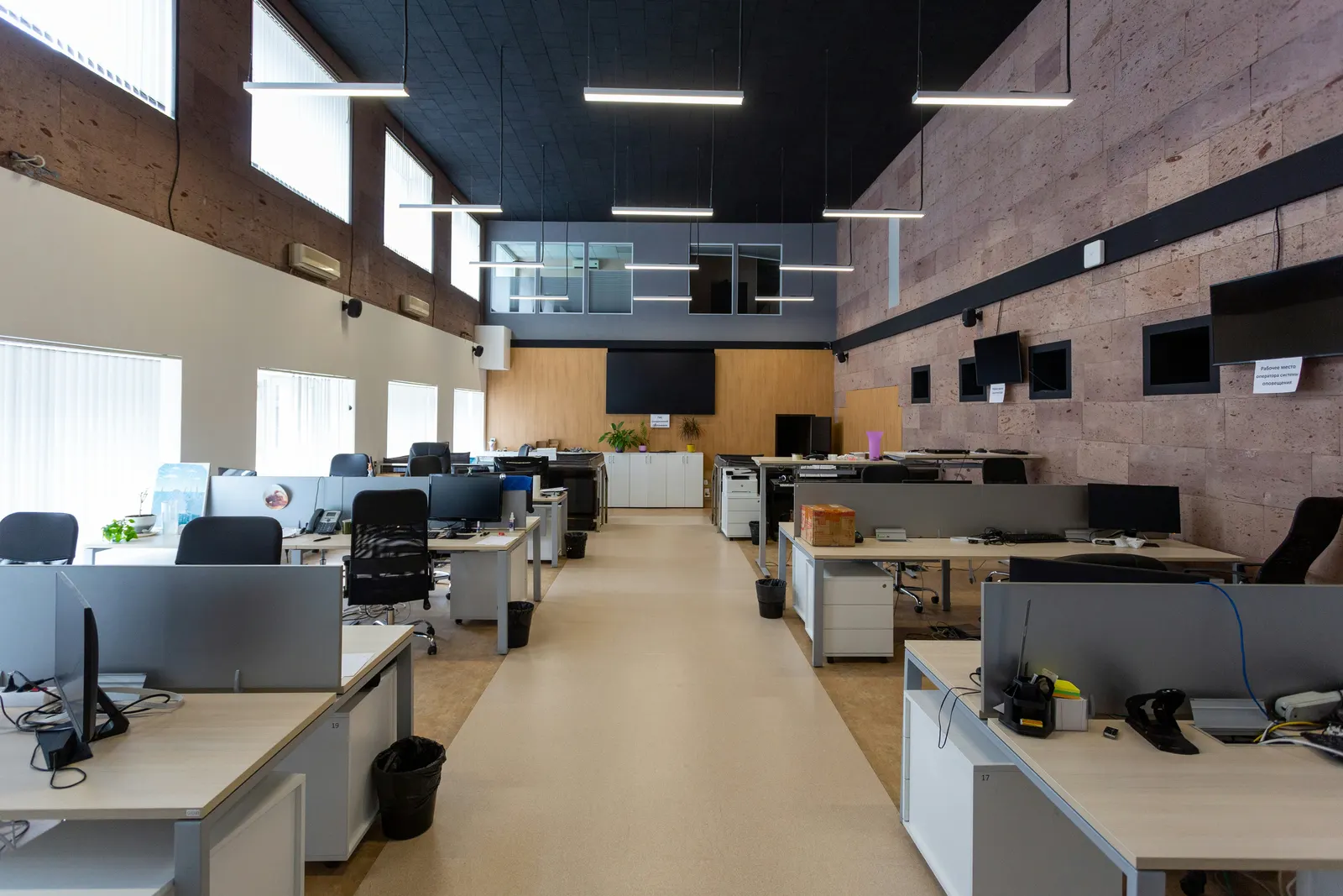 Open-plan office lit by suspended linear LED fittings