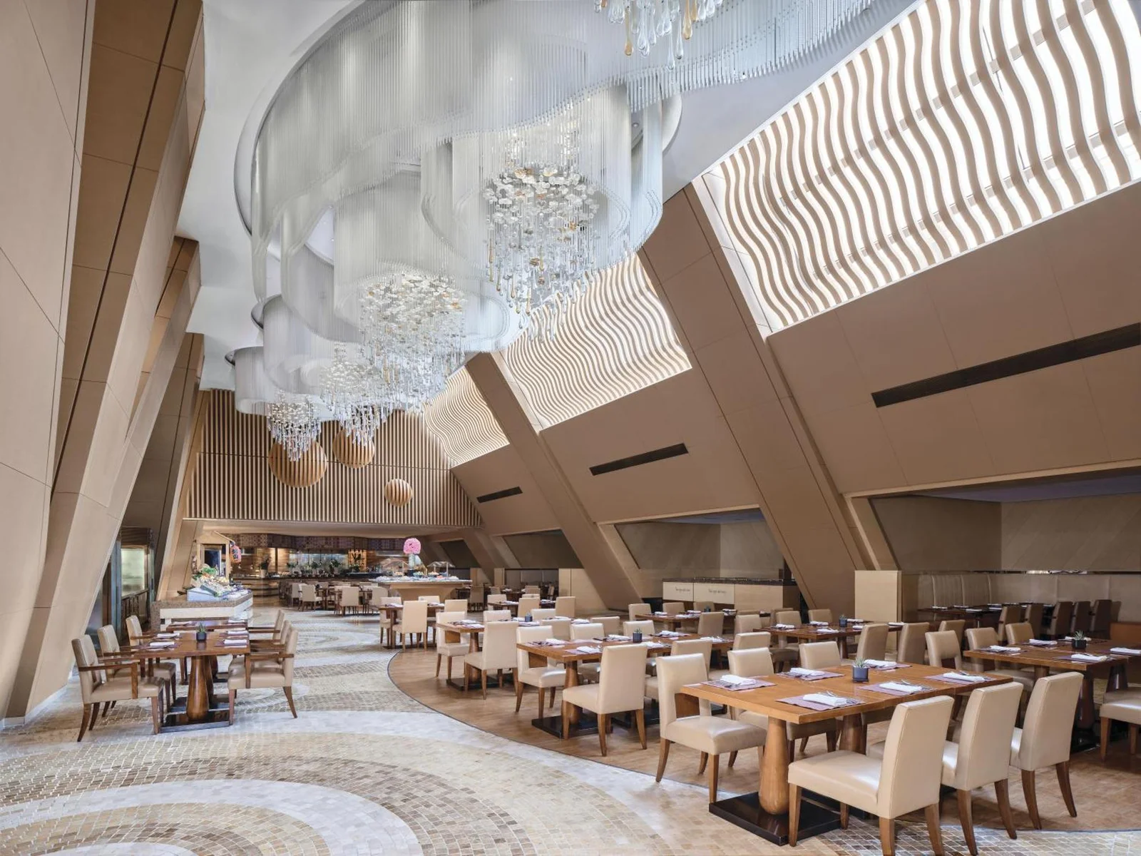 Hotel atrium restaurant under a cascade of crystal chandeliers
