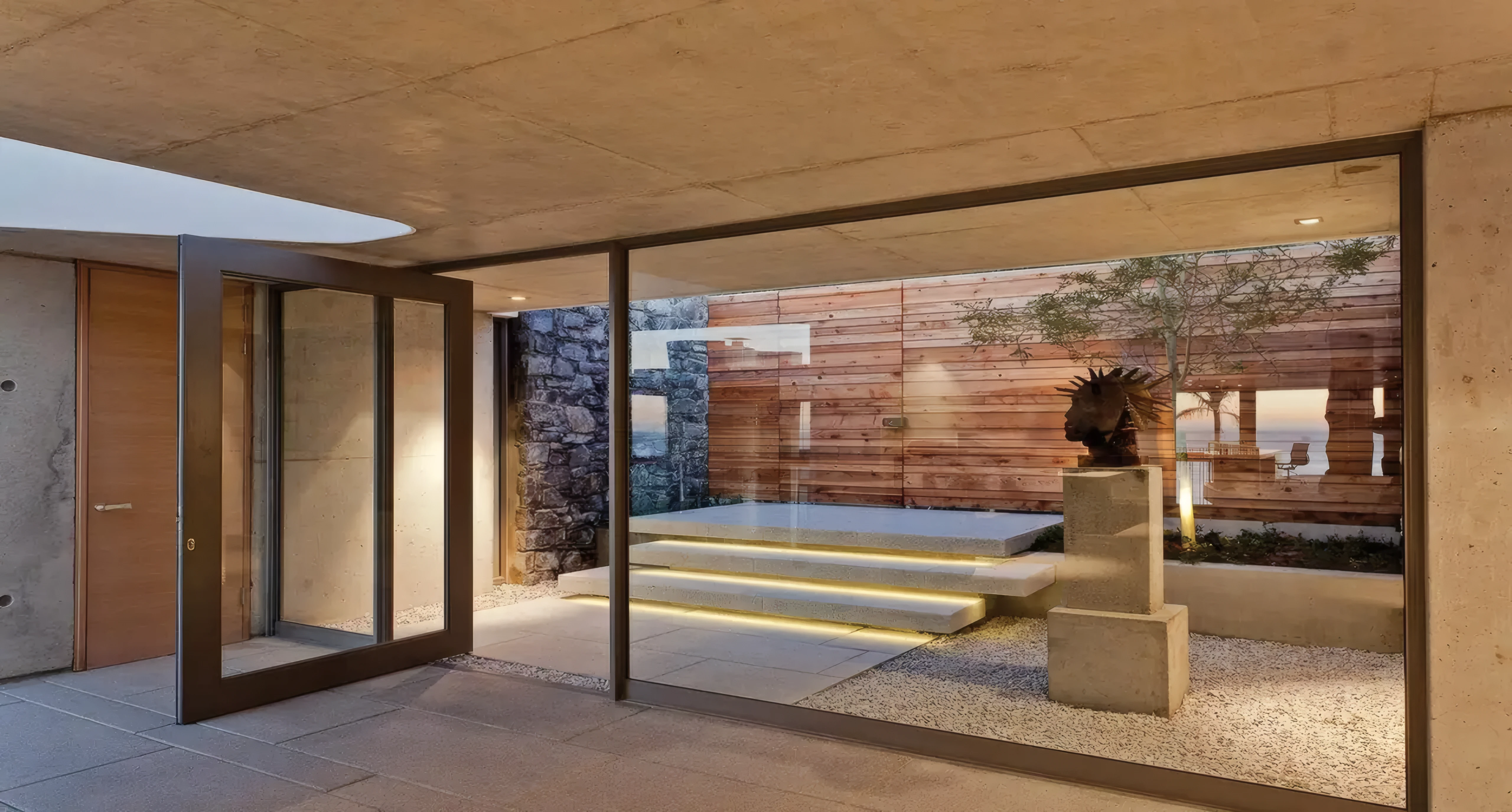 Warm LED strip lighting tracing the edge of stone entrance steps at dusk